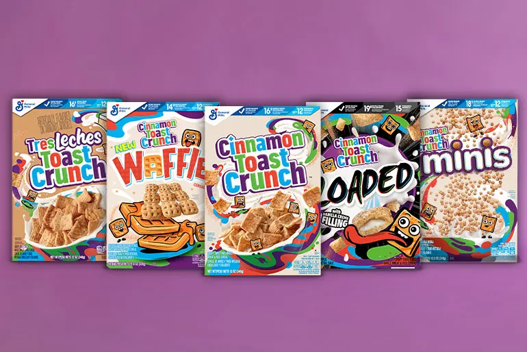 Arranged grouping of Cinnamon Toast Crunch Cereal boxes against a purple background.