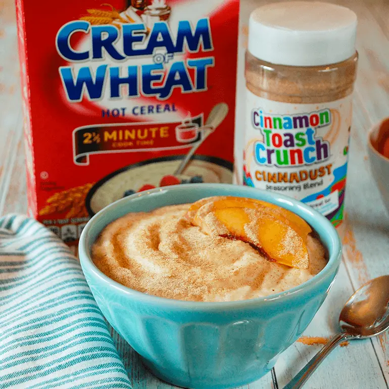 A bowl of Cinnadust™ Cream of Wheat in front of both the ingredient packages.