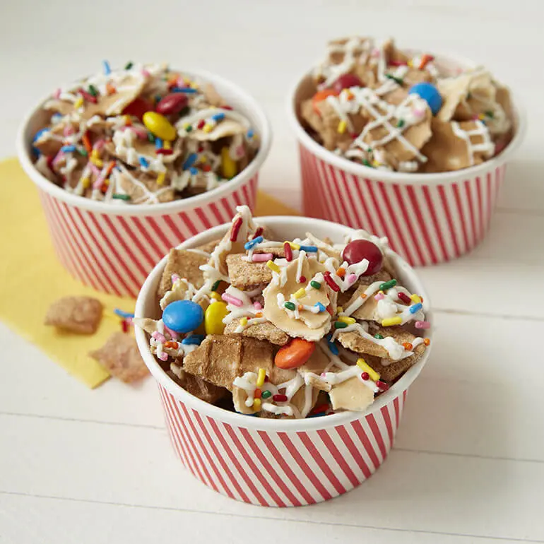 Cinnamon Toast Crunch™ Waffle Cone Snack Mix filling 3 different cardboard cups.